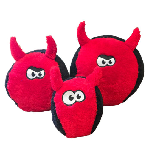 Three red plush devil toys with black edges and cartoon eyes, stacked together.
